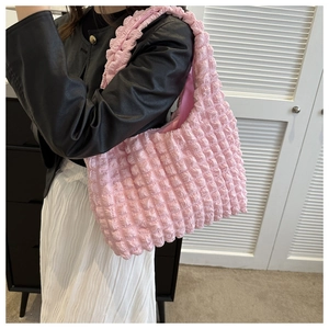 Detail of pink bubble texture pleated handbag with large capacity and soft fabric design
