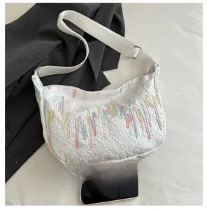 Detail of white baguette bag with FF embossing and colorful wavy line embroidery