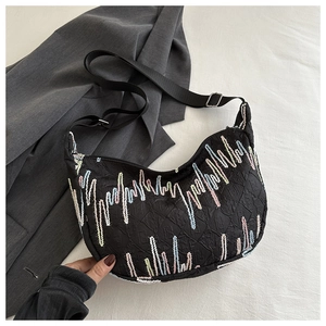 Detail of black nylon half-moon bag featuring unique colorful contrast wave embroidery