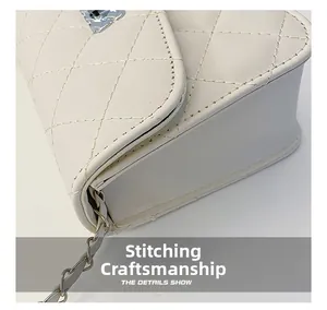 Detail of white quilted PU leather crossbody bag with precision stitching and chain strap