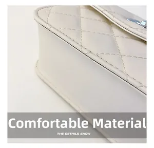 Detail of white quilted faux leather texture and precise stitching on a flap bag