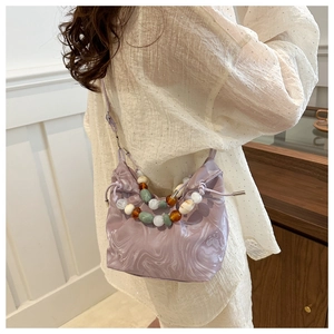 Close-up of light purple marble pattern drawstring bucket bag with decorative beads