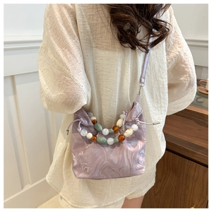 Detail of lavender marble bucket bag with beaded handle and drawstring closure