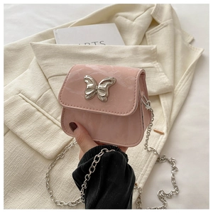 Detailed close-up of pink mini bag with silver butterfly metal hardware and chain