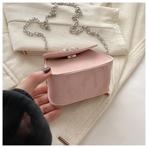 Detailed side view of pink crinkle mini bag with silver chain and metal clasp