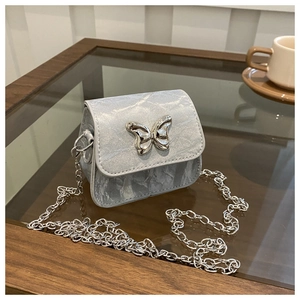 Detail of mini silver crossbody bag with butterfly lock and fine chain strap