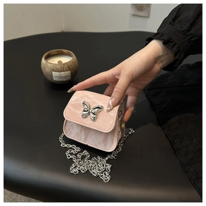 Detailed close-up of pink marble pattern mini bag with silver butterfly chain clasp