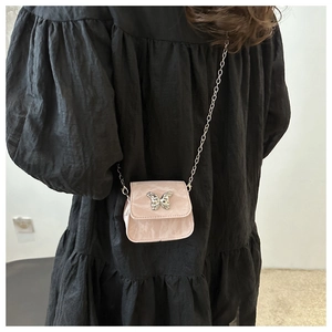Detailed view of pink mini crossbody bag with marble pattern and silver butterfly buckle