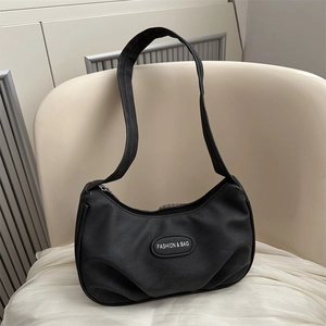 Chic black crescent underarm bag with pleated texture and stylish logo plaque
