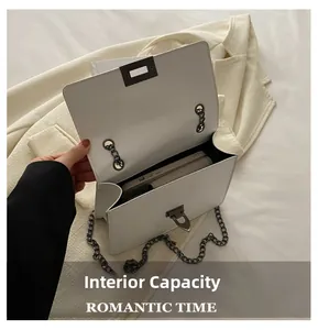 Interior view of white chain crossbody bag showing capacity for phone and card holder