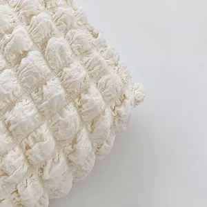Macro shot of off-white ruched fabric texture with dense 3D bubble pleats for women bag