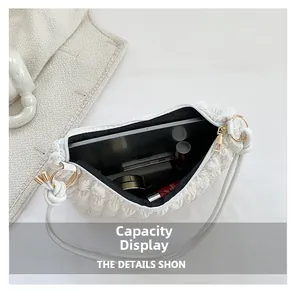 Internal view showing capacity of white ruched shoulder bag with gold zipper and lining