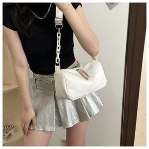 Close-up of a white nylon shoulder bag featuring thick chain decor and woven strap