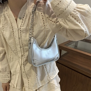 Silver metallic crescent underarm bag with chunky chain strap and futuristic mirror finish