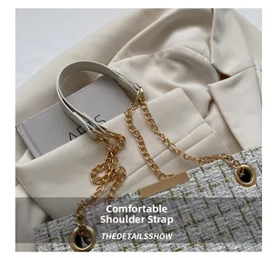 Close-up of beige tweed shoulder bag with gold metallic weaving and chain strap details