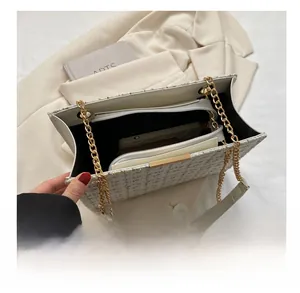 Internal view of white tweed shoulder bag showing inner zipper pocket and storage capacity