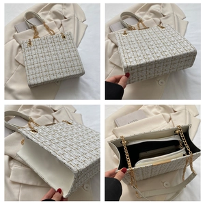 Detail of tweed shoulder bag with golden chain and organized interior compartments