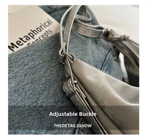 Detailed macro view of the adjustable silver metal buckle on a shoulder bag strap