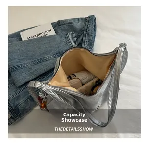 Detailed internal capacity view of the large silver tote bag with yellow fabric lining