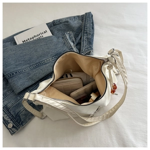 Internal view of white PU leather bag showing spacious capacity for phone and wallet