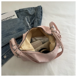 Pink crossbody bag interior view showing large capacity for umbrella and cosmetics