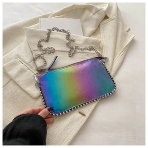 Detailed close-up of holographic crossbody bag with silver beaded trim and chain strap