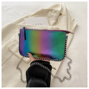 Close-up of holographic laser bag with silver studs and chain strap details