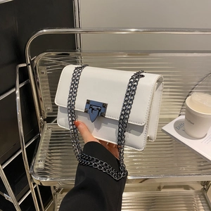 Minimalist white leather crossbody bag with black chain strap and metal lock closure