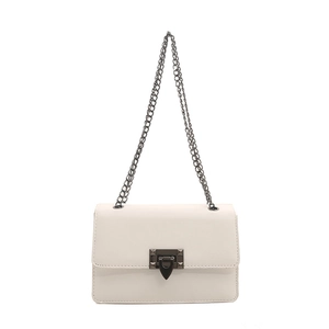 Minimalist cream white flap crossbody bag with chain strap and metallic lock closure