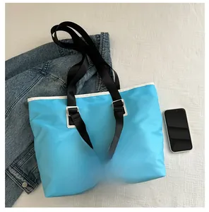 Detailed size comparison of light blue waterproof tote bag next to a smartphone