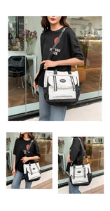 Detail of black and white canvas tote bag with flap pocket and adjustable straps