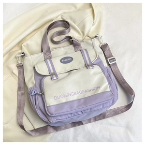 Detail of multi-functional tote bag with adjustable strap and side pockets for storage