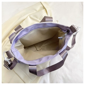 Interior view of large capacity canvas tote bag with zipper closure and purple shoulder strap