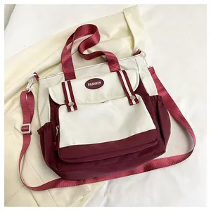 Detail of color-block tote bag with adjustable woven strap and fashion patch logo