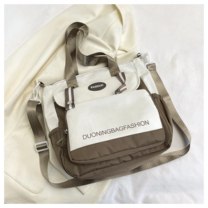 Detailed top view of contrast tote bag with beige and coffee tones on soft fabric