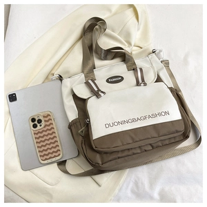 Close-up of dual-tone canvas bag with Fashion label and adjustable shoulder strap