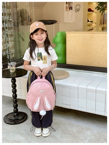 Pink rabbit backpack for girls featuring long ears and white pom-pom tail detail