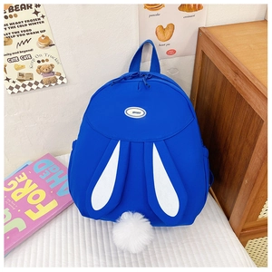 Detail of blue bunny backpack featuring soft white plush tail and decorative ears
