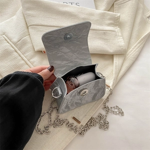 Mini marble textured crossbody bag with silver butterfly chain strap and magnetic flap