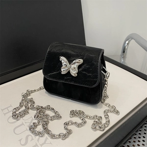 Mini black crossbody bag with silver butterfly buckle and chunky chain strap