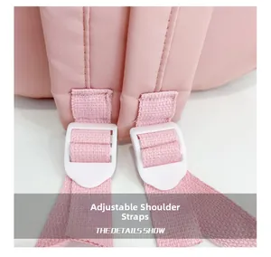 Detail of adjustable pink shoulder straps with white buckles on sweet girl's backpack