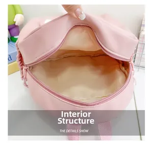 Internal structure of pink nylon school backpack showing spacious main compartment and lining