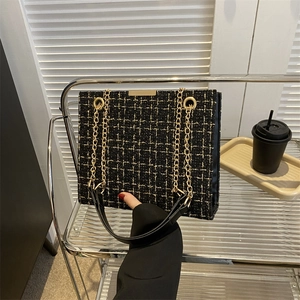 Elegant black and gold tweed shoulder bag with chain strap for office commute fashion