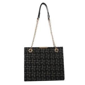 Minimalist black tweed chain shoulder bag with gold hardware and classic plaid texture