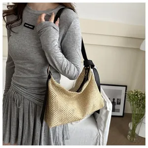 Detailed view of handmade woven beige tote bag with black leather shoulder straps