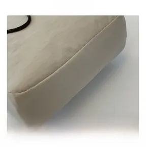 Detailed macro view showing the precision stitching and nylon fabric texture of the bag