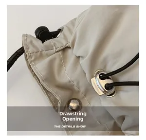 Macro shot of nylon bag drawstring opening with metal stopper and silver snap button