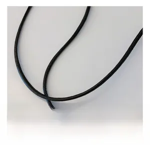 Detail of a black circular braided nylon shoulder strap for crossbody bags and phones