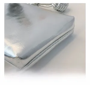 Detail showing the silver metallic mirror finish and precise stitching of the handbag