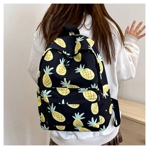Student backpack with yellow pineapple pattern showing back view on a model